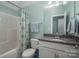 Bathroom with a tub and shower, granite vanity, and a toilet; all in a soothing color scheme at 6029 Bountiful St, Belmont, NC 28012