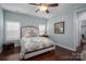 Tranquil bedroom with a ceiling fan, hardwood floors, and plantation shutters at 6029 Bountiful St, Belmont, NC 28012