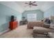 Inviting bedroom features a ceiling fan, work space, colorful quilt, and a comfortable sitting area near the window at 6029 Bountiful St, Belmont, NC 28012