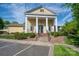 Community clubhouse featuring a welcoming entrance with columns, manicured landscaping, and convenient parking at 6029 Bountiful St, Belmont, NC 28012