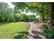 Expansive green common area with mature trees and a charming brick pathway, perfect for leisurely strolls at 6029 Bountiful St, Belmont, NC 28012