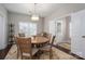 Dining room features a round table, chandelier lighting, and an open entrance to the foyer at 6029 Bountiful St, Belmont, NC 28012
