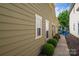 Home exterior showing well-maintained landscaping and a pathway leading to outdoor seating area at 6029 Bountiful St, Belmont, NC 28012