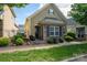Charming home featuring a combination of stone and shingle siding, complemented by manicured landscaping at 6029 Bountiful St, Belmont, NC 28012