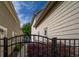 Side yard view of the home with a metal fence in the foreground and landscaped walkway at 6029 Bountiful St, Belmont, NC 28012