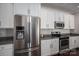 Stylish kitchen with stainless steel appliances and ample white cabinet storage at 6029 Bountiful St, Belmont, NC 28012