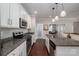Modern kitchen with granite countertops, stainless steel appliances, and pendant lighting at 6029 Bountiful St, Belmont, NC 28012
