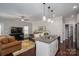 Open concept living room with a kitchen island, hardwood floors, and neutral walls at 6029 Bountiful St, Belmont, NC 28012