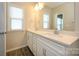Bathroom featuring double sink vanity with quartz countertop, modern fixtures, and wood flooring at 604 Tudor Park Way, Charlotte, NC 28211