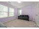 Cozy bedroom featuring plush carpeting, a large window, and a comfortable couch at 604 Tudor Park Way, Charlotte, NC 28211