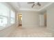 Bright bedroom with neutral walls, ceiling fan, and doorways to the bathroom and additional room at 604 Tudor Park Way, Charlotte, NC 28211