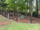Dog park fenced with green lawns and mature trees at 604 Tudor Park Way, Charlotte, NC 28211