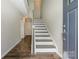 Welcoming entryway with hardwood floors, leading to a staircase and featuring an elegant front door at 604 Tudor Park Way, Charlotte, NC 28211
