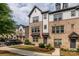 Charming townhomes featuring brick and siding accents with inviting curb appeal on a sunny day at 604 Tudor Park Way, Charlotte, NC 28211