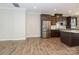 Open kitchen view with stainless steel appliances, dark cabinets, and quartz countertops at 604 Tudor Park Way, Charlotte, NC 28211