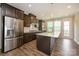 Modern kitchen featuring stainless steel appliances, a large island, and dark wood cabinets at 604 Tudor Park Way, Charlotte, NC 28211