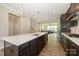 Open kitchen with a large island, stainless steel appliances, and view to the living room at 604 Tudor Park Way, Charlotte, NC 28211