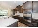 Modern kitchen features stainless steel appliances, dark cabinets, and quartz countertops at 604 Tudor Park Way, Charlotte, NC 28211