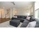 Open-concept living room with large sectional, modern lighting, and staircase access at 604 Tudor Park Way, Charlotte, NC 28211