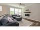 Inviting living room featuring a large sectional sofa, fireplace, and ample natural light at 604 Tudor Park Way, Charlotte, NC 28211