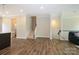 Open concept living room view from kitchen, featuring wood flooring and neutral tones at 604 Tudor Park Way, Charlotte, NC 28211