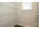 Walk-in pantry closet featuring wire shelving and wood-look flooring at 604 Tudor Park Way, Charlotte, NC 28211