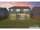 Spacious backyard featuring a covered patio, well-maintained lawn, and a privacy fence at 6159 Holland St, Fort Mill, SC 29707