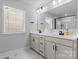 Modern bathroom features a double vanity with stone countertops and a large mirror at 6159 Holland St, Fort Mill, SC 29707