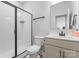 Modern bathroom features a glass-enclosed shower, vanity with sink, and neutral color scheme at 6159 Holland St, Fort Mill, SC 29707