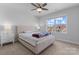 This bedroom offers a ceiling fan, carpeted floor, and natural light from a large window overlooking a community at 6159 Holland St, Fort Mill, SC 29707
