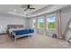 This primary bedroom features tray ceilings, windows, and carpet flooring at 6159 Holland St, Fort Mill, SC 29707