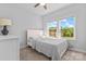 Cozy bedroom featuring a bed, bedside table and large window providing natural light at 6159 Holland St, Fort Mill, SC 29707