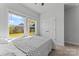 Sunlit bedroom showcasing a comfortable bed, large window and a view of the outdoors at 6159 Holland St, Fort Mill, SC 29707