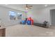 Spacious bonus room with natural light, featuring a circus tent and table and chairs at 6159 Holland St, Fort Mill, SC 29707