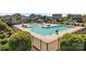 Fenced community pool with lounge chairs, water features, and clubhouse at 6159 Holland St, Fort Mill, SC 29707