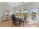 Well-lit dining room with a modern chandelier, wood floors, and a view of the backyard at 6159 Holland St, Fort Mill, SC 29707