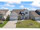Charming two-story home boasts a well-maintained lawn, attached garage, and tasteful landscaping at 6159 Holland St, Fort Mill, SC 29707
