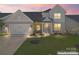 Charming two-story home with an attached garage, manicured lawn, and inviting front entrance at 6159 Holland St, Fort Mill, SC 29707