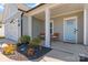 Inviting covered front porch with stylish columns, seating, and a colorful front door at 6159 Holland St, Fort Mill, SC 29707