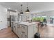 Well-lit kitchen with a center island, sink, stainless steel appliances, and ample cabinets at 6159 Holland St, Fort Mill, SC 29707