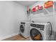 Well-lit laundry room with front loading washer and dryer, and storage shelving at 6159 Holland St, Fort Mill, SC 29707