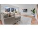 Open living room featuring a comfortable sectional sofa, large windows and wood flooring at 6159 Holland St, Fort Mill, SC 29707