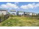 Fenced backyard featuring lush green grass and play areas, perfect for outdoor activities and Gathering enjoyment at 637 Scotch Meadows Loop, Monroe, NC 28110