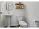 Bathroom featuring a pedestal sink, decorative shelves, and a modern toilet at 637 Scotch Meadows Loop, Monroe, NC 28110