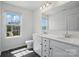 Bathroom featuring a dual sink vanity and view of the neighborhood through the window at 637 Scotch Meadows Loop, Monroe, NC 28110