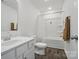 Bright bathroom featuring a white vanity, shower-tub combo with fresh white tile, and wood-look vinyl flooring at 637 Scotch Meadows Loop, Monroe, NC 28110