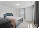 Cozy bedroom with a stylish bed frame, dresser, and soft carpet at 637 Scotch Meadows Loop, Monroe, NC 28110