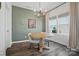 Bright dining area with a round table, stylish chandelier, and elegant green accent wall at 637 Scotch Meadows Loop, Monroe, NC 28110