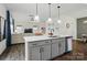 Modern kitchen with a large island, stainless steel appliances, and an open layout into the living area at 637 Scotch Meadows Loop, Monroe, NC 28110