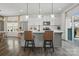 Stylish kitchen with white cabinets, stainless steel appliances, an island with bar stools, and glass pendant lights at 637 Scotch Meadows Loop, Monroe, NC 28110